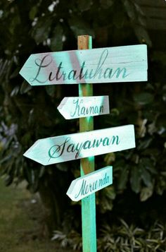 a wooden sign pointing in different directions