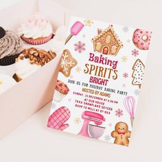 a box filled with lots of cupcakes next to a card that says baking spirits bright