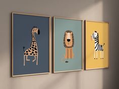 three framed pictures of animals hanging on a wall