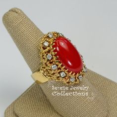 This beautiful oxtail red Coral Ring is set in 14k solid gold and a fancy diamond granulated setting!Ring Size: 7.25Total Weight: 17.17 gramsPrecious Metal: 14k solid goldPrecious stones:-Coral Center Stone: 20mm x 11mm-White Round diamonds: 0.4 ct Red Diamond Heirloom Ring For Formal Occasions, Red Heirloom Diamond Ring For Formal Occasions, Heirloom Red Diamond Ring For Formal Occasions, Vintage Red Diamond Jewelry, Red Heirloom Diamond Ring For Formal Events, Collectible Red 14k Stamped Jewelry, Antique Oval Red Diamond Ring, Antique Red Diamond Jewelry, Antique Red Oval Diamond Ring