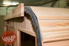 a close up of a wooden structure with a sign in the background that says dundalk leisure craft