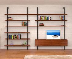 a living room filled with furniture and bookshelves next to a wall mounted tv