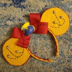 a close up of a mickey mouse head on a carpet with beads around it's ears