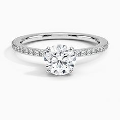 a round brilliant cut diamond ring with pave set shoulders