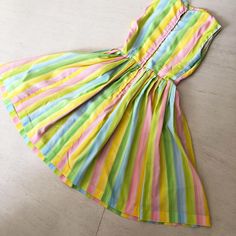 "Sweetest ever pastel 🌈 rainbow coloured dress! Sweetest ever!! Love the neckline on this one - so demure and elegant. Colors are nice and bright with no fade. Cupcake party anyone? Label: None. Well made. Condition: Excellent Bust 34/35\" Waist 26\" Length 38\" This item has been cleaned and is ready to wear. Comes from a smoke and pet free home. Don't forget to follow me on Instagram @tammaraclearshercloset for new listing alerts. This is shipping from Singapore. Standard post to the US takes Retro Multicolor A-line Dress, Fitted Rainbow Dresses In Playful Style, Playful Fitted Rainbow Dress, Fitted Playful Rainbow Dress, Retro Multicolor Dresses For Daywear, Spring Rainbow Fitted Dress, Spring Rainbow Cotton Dresses, Vintage Multicolor Spring Dresses, Rainbow Cotton Dresses For Spring