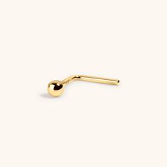 Our Tiny Secret Stud nose ring in 14k gold features a tiny sphere on a L-shaped nose ring. Symbolizing wholeness and completion, the Tiny Secret Stud gives you a touch of shine - perfect for minimalists and those who love dainty gold jewelry. Great to wear all day, every day - it's solid 14k gold, so you can leave it in 24/7. Specs & Sizing Solid 14k gold nose ring 2mm ball design 6.5mm post, 6mm after the bend, 20g wire (0.8MM) Tiny Yellow Gold Minimalist Nose Rings, Tiny Minimalist Yellow Gold Nose Rings, Minimalist 14k Yellow Gold Nose Rings, Stud Nose Ring, Tiny Nose Studs, L Shaped Nose Ring, Gold Nose Ring, Dainty Gold Jewelry, Cartilage Earrings Stud