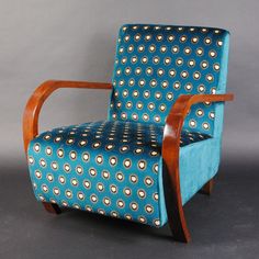 a blue and brown chair sitting on top of a gray floor