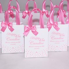 pink and white gift bags with bows on them that say happy birthday to someone special