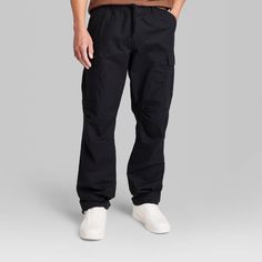 Solid-color pants tailored in a regular fit with tapered legs. Mid-rise cut with an elasticized waistband with drawstring for a secure fit. Made of midweight cotton with a hint of stretch for breathable, flexible wear that moves with you. Cargo pockets on the legs plus side and back pockets complete the look with functional flair. If you’re not satisfied with any Target Owned Brand item, return it within one year with a receipt for an exchange or a refund. Original Use™: Always the next evolutio Washed Black Relaxed Fit Cargo Pants, Black Relaxed Fit Cargo Pants, Washed Black Relaxed Fit Cotton Cargo Pants, Black Relaxed Fit Ankle-length Cargo Pants, Men’s Black Cargo Pants, Men's Cargo Pants, Pants Tailored, Color Pants, Solid Color Pants