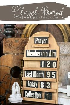 a wooden sign sitting on top of a table next to a clock and other items