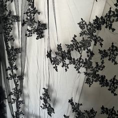 black and white photograph of sheer fabric with flowers