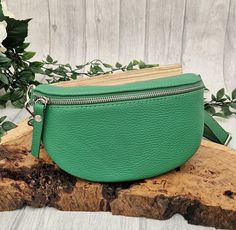 This green Italian leather hip bag is an updated street-ready design of the bum bag, which helps you keep your essentials organized and your hands free. This one design can be worn 3 different ways: around the waist like the traditional bum bag, across body to give it that modern vibe or over-shoulder which again gives it that updated look. Absolutely perfect for holidays and days or nights out. Different colours and different ways to wear the bag can be seen in the photographs. Wear it with the strap which comes with the bag, or team it up with one of our patterned bag straps. This hip bag COMES WITH THE STANDARD slim line LEATHER STRAP in the same colour as the hip bag, as shown in pictures 1 to 6. The additional print patterned bag strap shown in the other photograph is for illustration Green Belt Bag With Zipper Pocket For Everyday Use, Green Leather Belt Bag For Daily Use, Green Modern Crossbody Belt Bag, Modern Green Crossbody Belt Bag, Green Leather Belt Bag For Everyday Use, Green Pouch Belt Bag With Zipper Pocket, Green Belt Bag For Everyday With Mobile Phone Holder, Green Belt Bag With Mobile Phone Pouch, Green Belt Bag With Zipper Pocket