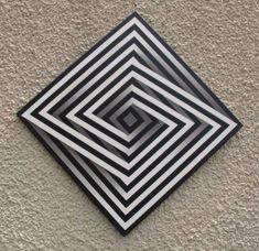 a black and white square on the side of a building