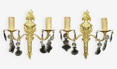 three golden candelabra with candles and decorations