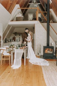 a bride and groom are standing in front of the fire place at their wedding reception