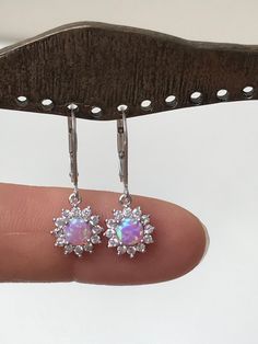 "Dainty and Petite Pink Opal and CZ dangle earrings -Metal: .925 Sterling Silver -Stone: Lab created Pink Opal measures 5mm -Measurements: Earrings dangle approx. 1\" from top of ear wire -Lever Back Earrings Please feel free to Convo me with any questions before purchasing. Please view policy before purchasing Other Opal Earrings can be found here https://www.etsy.com/shop/LinksAndStones?ref=listing-shop-header-item-count§ion_id=24232786 Thank You For Visiting My Shop" Sparkling Silver Dangle Cluster Earrings, Silver Dangle Cluster Earrings With Sparkling Stones, Sterling Silver White Gold Dangle Cluster Earrings, White Gold Sterling Silver Dangle Cluster Earrings, Sterling Silver Dangle Cluster Earrings, Silver Dangle Cluster Earrings As Gift, Silver Dangle Cluster Earrings Fine Jewelry, Sterling Silver Sparkling Drop Earrings, Sparkling Sterling Silver Drop Earrings