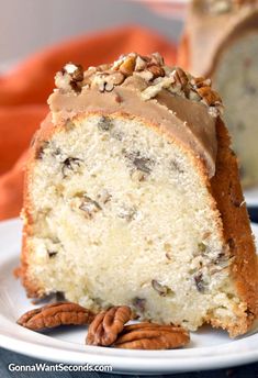 a piece of cake with pecans on the side