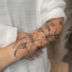 a woman with a flower tattoo on her arm