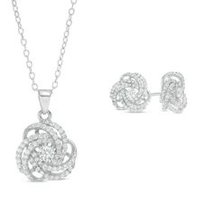 Make any day special with this shimmering pendant and stud earrings set. Crafted in sterling silver, the pendant features a sparkling 3.0mm lab-created bright white sapphire at the center of a double-row orbit love knot adorned with smaller created sapphires. The pendant suspends along an 18.0-inch cable chain that secures with a spring-ring clasp. The coordinating post earrings are centered with 4.0mm created sapphires and secure comfortably with friction backs. Buffed to a brilliant luster, th White Gold Pendant Jewelry Set For Anniversary, White Gold Pendant Jewelry Sets For Anniversaries, White Sterling Silver Jewelry Sets With Diamond Cut, Sterling Silver Jewelry Sets With Diamond Cut In White, Sterling Silver Diamond Cut Jewelry Set In Diamond White, White Gold Jewelry Sets With Sparkling Stones For Anniversary, Dazzling White Sterling Silver Jewelry Sets, Anniversary Sterling Silver Jewelry Sets With Sparkling Stones, Love Knot