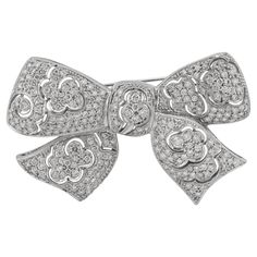 This elegant brooch in a bow tie design, crafted with all brilliant diamonds with a total carat weight of 4.16. Sophia D by Joseph Dardashti LTD has been known worldwide for 35 years and are inspired by classic Art Deco design that merges with modern manufacturing techniques. Formal Brooches With Diamond Accents, Elegant Anniversary Brooch With Bow, Luxury Diamond Brooches For Formal Occasion, Elegant Brilliant Cut Brooches As Gifts, Formal Diamond White Brilliant Cut Brooch, Elegant Diamond Accented Brooch Gift, Luxury Diamond White Brooches For Formal Events, Luxury Diamond White Brooches For Formal Occasions, Elegant Diamond Accents Brooch For Gift