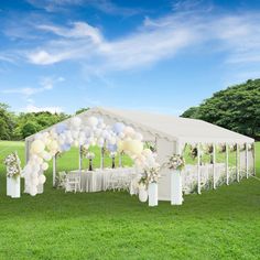 a white tent with balloons and flowers on the grass