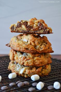 chocolate chip cookies stacked on top of each other with marshmallows around them