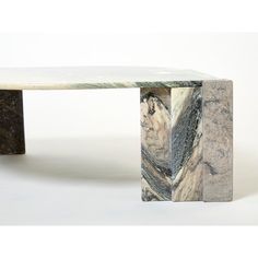 a marble table with an interesting design on it's top and bottom, sitting against a white background