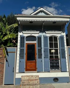 an old house with shutters and wooden doors