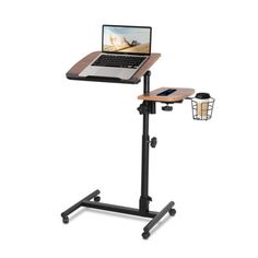 a laptop computer sitting on top of a wooden table next to a black metal stand