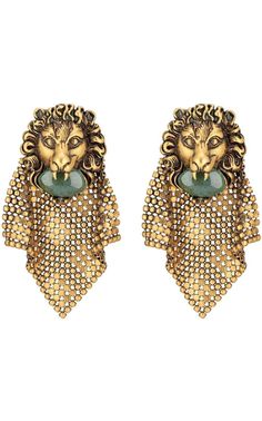 The lion head holds a green cabochon glass stone and is enriched with an intricate diamond-shaped beaded mesh detail. Metal with aged gold finish Lion head with agate green coloured cabochon glass stone Mesh metal detailAntique effect gold-tone hardware, Clip-on Lion head: 35mm x 40mm 86mm total length Material: Brass, cabochon glass stone, leaded crystalMade in Italy Chevron Jewelry, Gucci Runway, Lion Earrings, Head Chain, Buy Gucci, Chain Mail, Lion Head, Online Earrings, The Lion