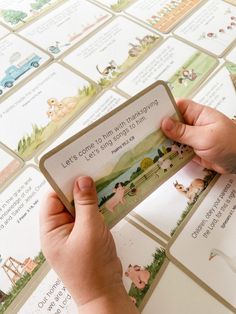 a person is holding up a card with pictures on it that says let's go to the farm