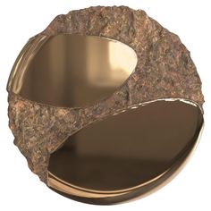 a close up of a metal object with rocks on it's sides and an oval mirror in the middle