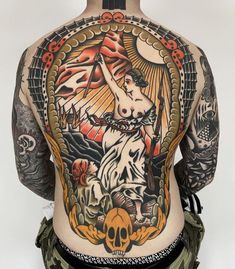 the back of a man's body with tattoos on it and an eagle above his head