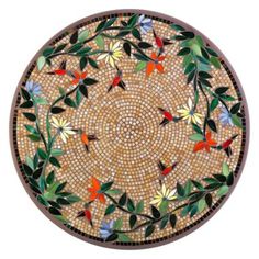 a round mosaic with flowers and leaves on it