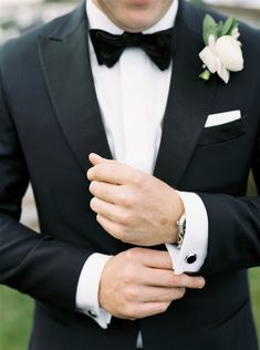 a man in a tuxedo with a flower on his lapel