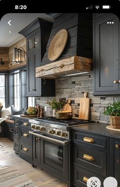 an image of a kitchen setting with black cabinets and wood accents on the countertops