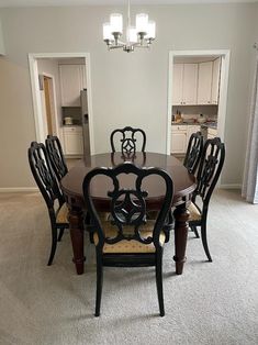 a dinning room table with chairs and a chandelier