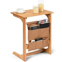 a wooden table with two pockets for books and magazines on it, next to a glass of orange juice