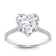 a heart shaped diamond ring with diamonds on the band