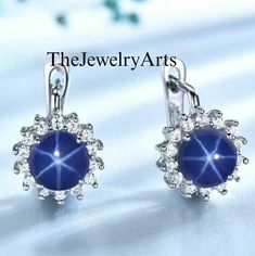 "Most Welcome to \"TheJewelryArts\" Products Description Center Stone: Genuine Lindy Star Sapphire Center Stone Size: 7x7mm Stone Shape: Round Cabochon Side Stone : Cubic Zircon Stone Clarity: VVS Material: 92.5 Sterling Silver, also available in 24k Rose Gold Vermeil/Gold Vermeil/Black Vermeil Stamp: 92.5 ➽OCCASION: Surprise your loved one with this beautiful engagement/wedding jewelry by TheJewelryArts . A classic piece of jewelry for all men/women in your life, this is a perfect gift for any occasion such as birthdays, anniversaries, wedding, engagements, Valentine's Day or Christmas day mother's day. ✔Comfort Fit ✔Nickel Free ✔Free Engraving ✔ Free Shipping ✔  Ready to Ship in 3 Business Day Customization is always welcome and please feel free to contact with me if you have any design Elegant Hypoallergenic Star Earrings, Silver Star Clip-on Earrings For Gift, Elegant Blue Star-shaped Jewelry, Blue Star-shaped Sterling Silver Earrings, Blue Sterling Silver Star Earrings, Anniversary Jewelry With Star-shaped Matching Earrings, Anniversary Jewelry With Matching Star Earrings, Anniversary Star-shaped Jewelry With Matching Earrings, Blue Star-shaped Jewelry For Formal Occasions