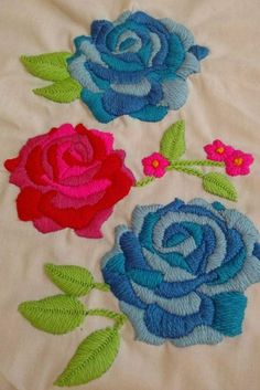 three roses on a white sheet with green leaves and pink flowers in the center,