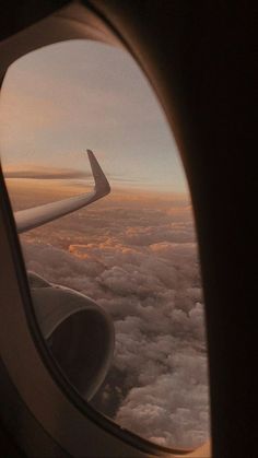 an airplane window looking out over the clouds