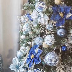 a christmas tree with blue and white ornaments