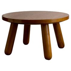 a wooden table with three legs and a round shape on the top, against a white background