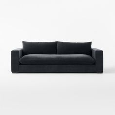 a black couch sitting on top of a white floor