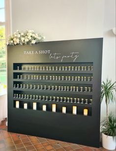 there is a display with candles on the wall