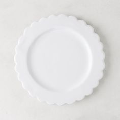 an empty white plate with scalloped edges