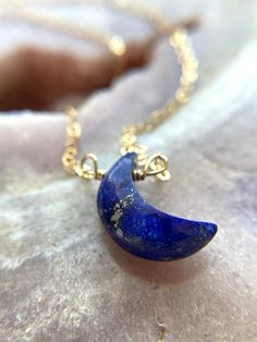 "Stunning 16mm blue Lapis Lazuli Crescent moon pendants have been made into a beautiful crystal necklace. In options of gold or silver this necklace is a show stopper. Perfect gift for that special someone in your life, they will cherish this handmade piece for years to come and will be a luxurious classic necklace to add to their wardrobe. This piece looks great worn alone or layered with other classy pieces. Handcrafted Lapis Lazuli Moon Pendant Necklace *Beautiful gift for her *High quality g Spiritual Blue Moon Necklaces, Sapphire Crystal Necklace For Gift, Celestial Wire Wrapped Pendant Necklace, Celestial Style Wire Wrapped Pendant Necklace, Blue Spiritual Crystal Necklace With Round Pendant, Spiritual Round Lapis Lazuli Necklace, Handmade Sapphire Crystal Necklaces As Gift, Handmade Sapphire Crystal Necklace Gift, Handmade Sapphire Crystal Necklace For Gift