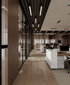 an office with wooden floors and glass walls