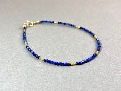 LAPIS LAZULI BRACELET IN GOLD FILLED AND VERMEIL This pretty bracelet, made from dark blue Lapis Lazuli beads has a length of 17.5cm.  If you like another length, please specify when ordering. I send all my jewelry packaged in a small jewelry pouch. MATERIAL Lapis Lazuli beads 1,7 mm 14K Gold filled Clasp Vermeil beads (silver goldplated) 1,5mm Blue Faceted Beads Friendship Bracelets As Gift, Handmade Adjustable Lapis Lazuli Bracelets, Blue Friendship Bracelets With Faceted Beads For Gift, Sapphire Lapis Lazuli Bracelets As Gift, Handmade Adjustable Sapphire Jewelry, Blue Bracelets With Faceted Beads As A Gift, Blue Bracelet With Faceted Beads For Gift, Adjustable Lapis Lazuli Beaded Bracelet With Faceted Beads, Blue Bracelets With Faceted Beads For Gift